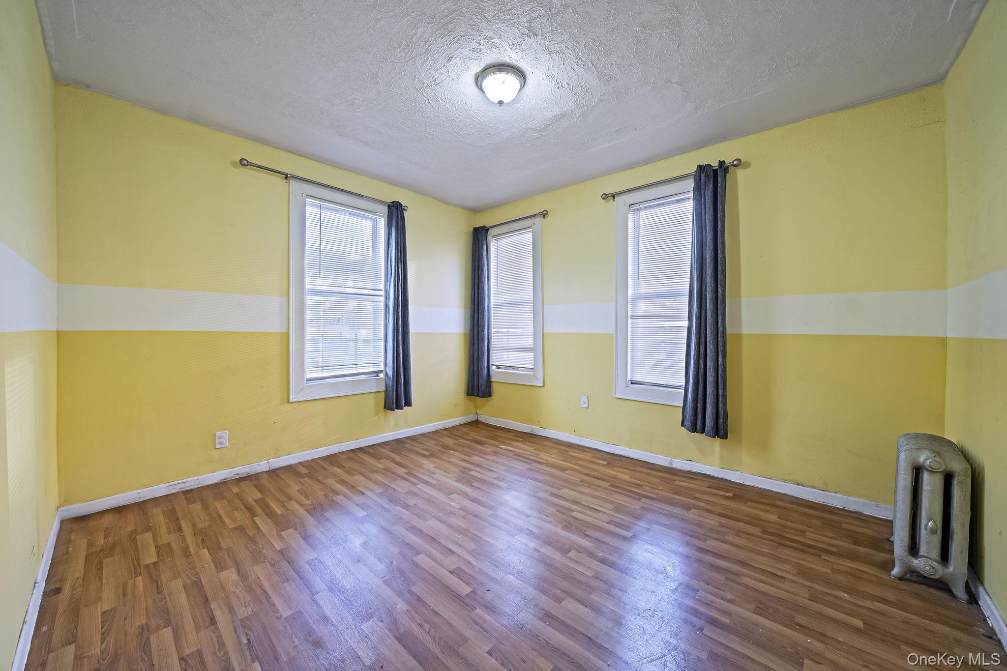 108-76 38th Avenue Queens, NY 11368 - Photo 8 of 38 a view of room with window and wooden floor