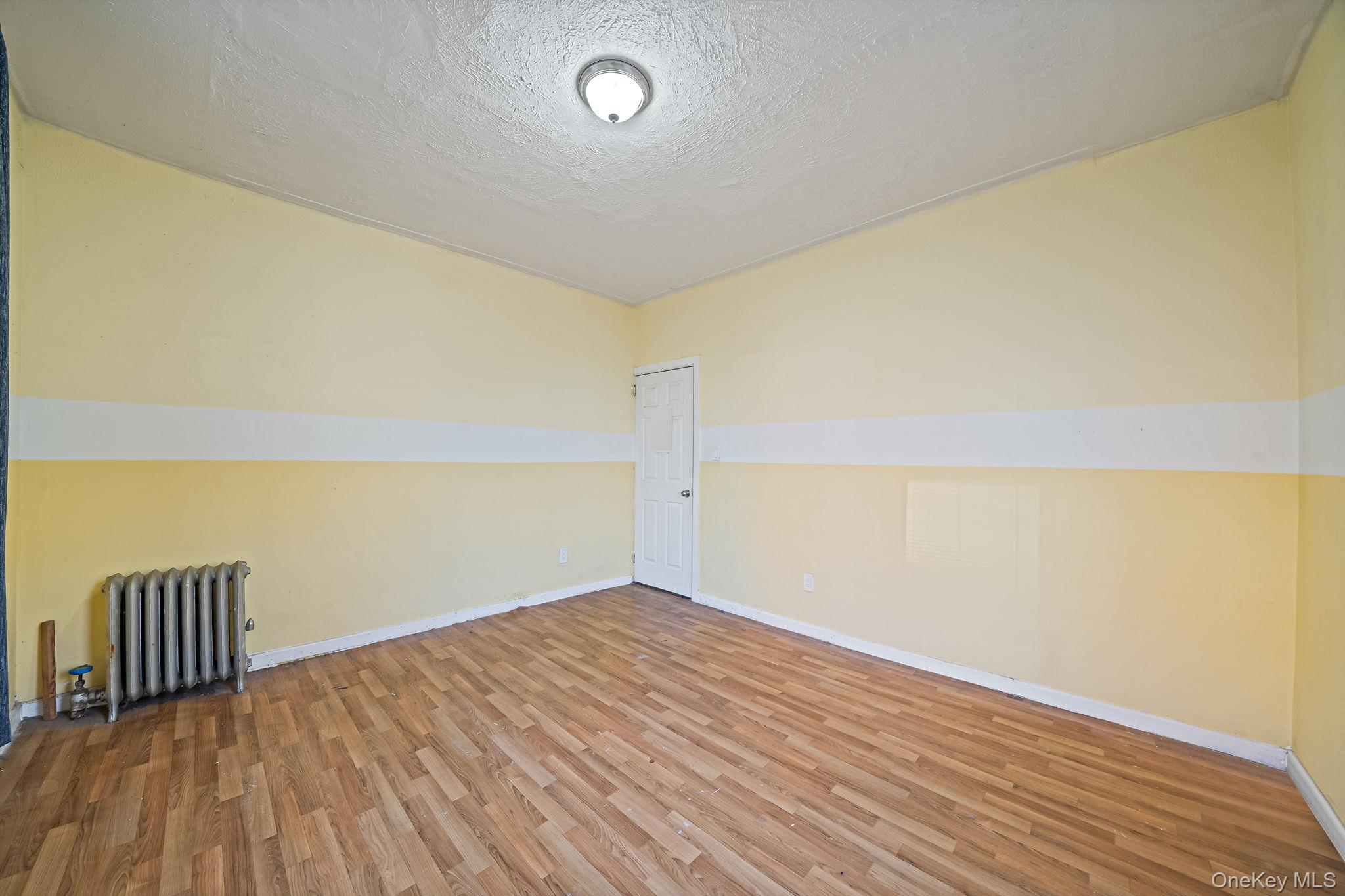 108-76 38th Avenue Queens, NY 11368 - Photo 9 of 38 a view of wooden floor and brick walls