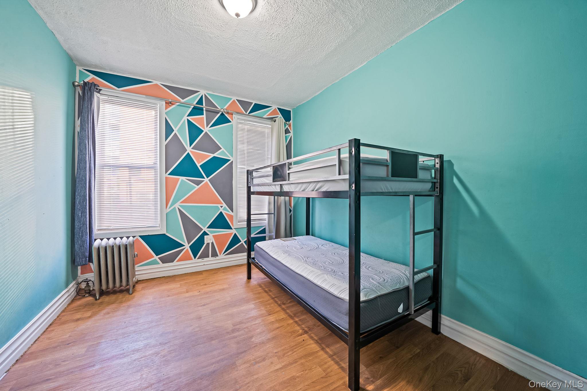 108-76 38th Avenue Queens, NY 11368 - Photo 10 of 38 a bedroom with a bed and a window