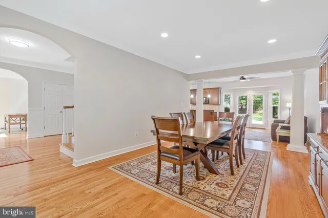 a living room with furniture wooden floor and a large window
