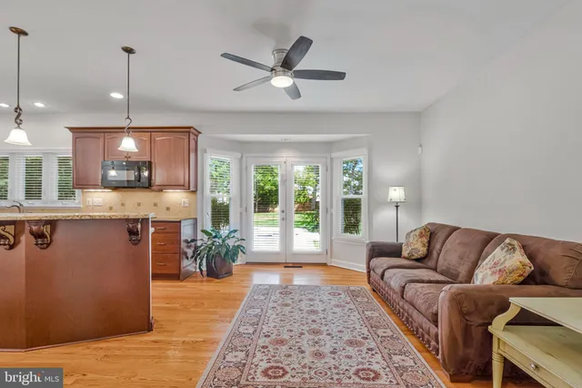 a kitchen with stainless steel appliances granite countertop a refrigerator a stove and a wooden floors