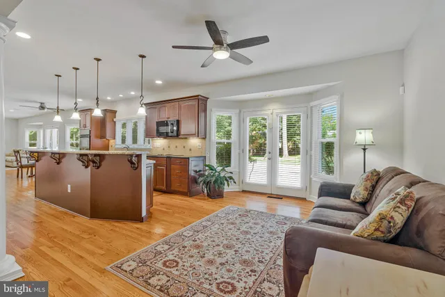 a dining room with furniture a floor to ceiling window and wooden floor