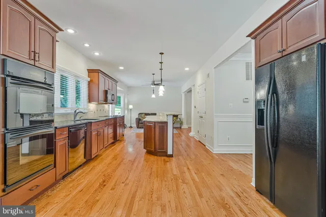 a living room with furniture and kitchen view