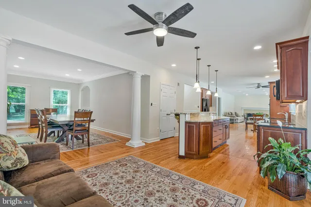 a living room with fireplace furniture and a wooden floor