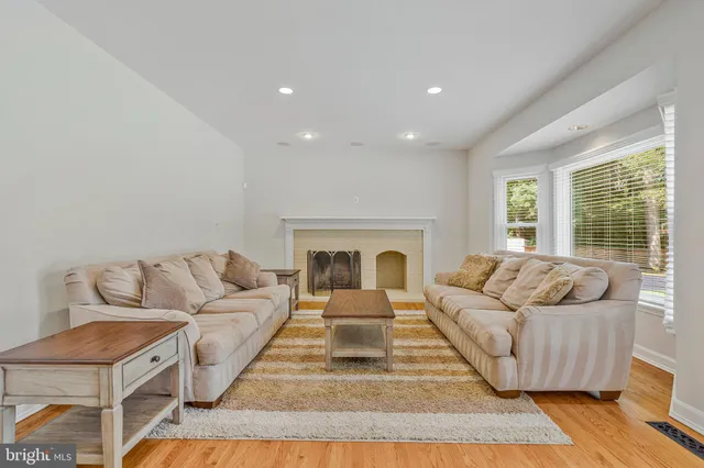 a bathroom with a granite countertop sink and a bathtub
