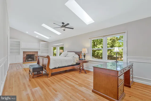 a spacious bedroom with a bed and a ceiling fan