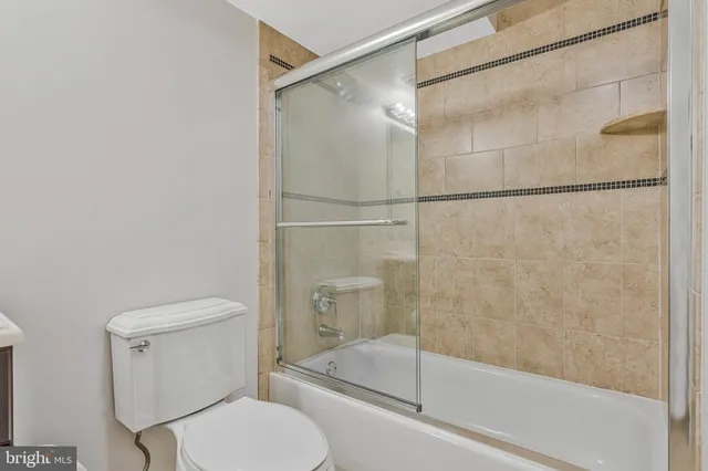 a view of a yard with plants and large trees