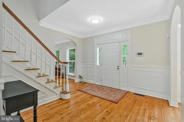 a view of entryway and hall with wooden floor