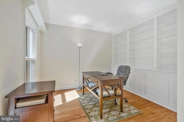 a living room with a rug couches and a coffee table