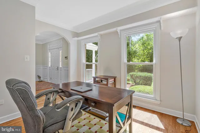 a dining room with furniture and wooden floor