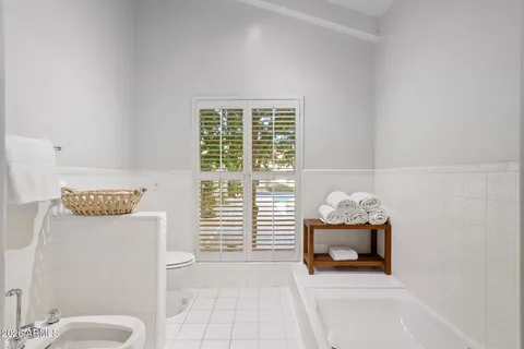 a bathroom with a double vanity sink mirror and shower