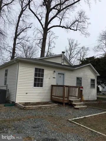 a view of a house with a yard and a tree