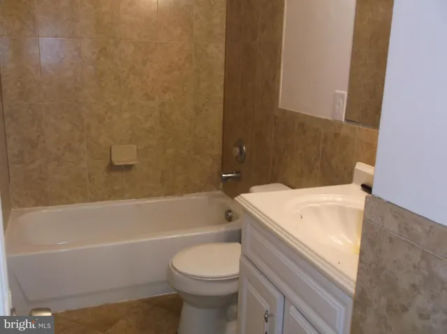 a bathroom with a sink a toilet and bathtub