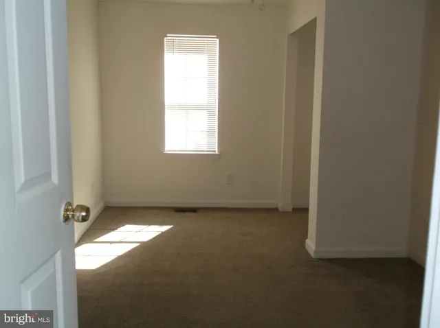 a view of an empty room and a window
