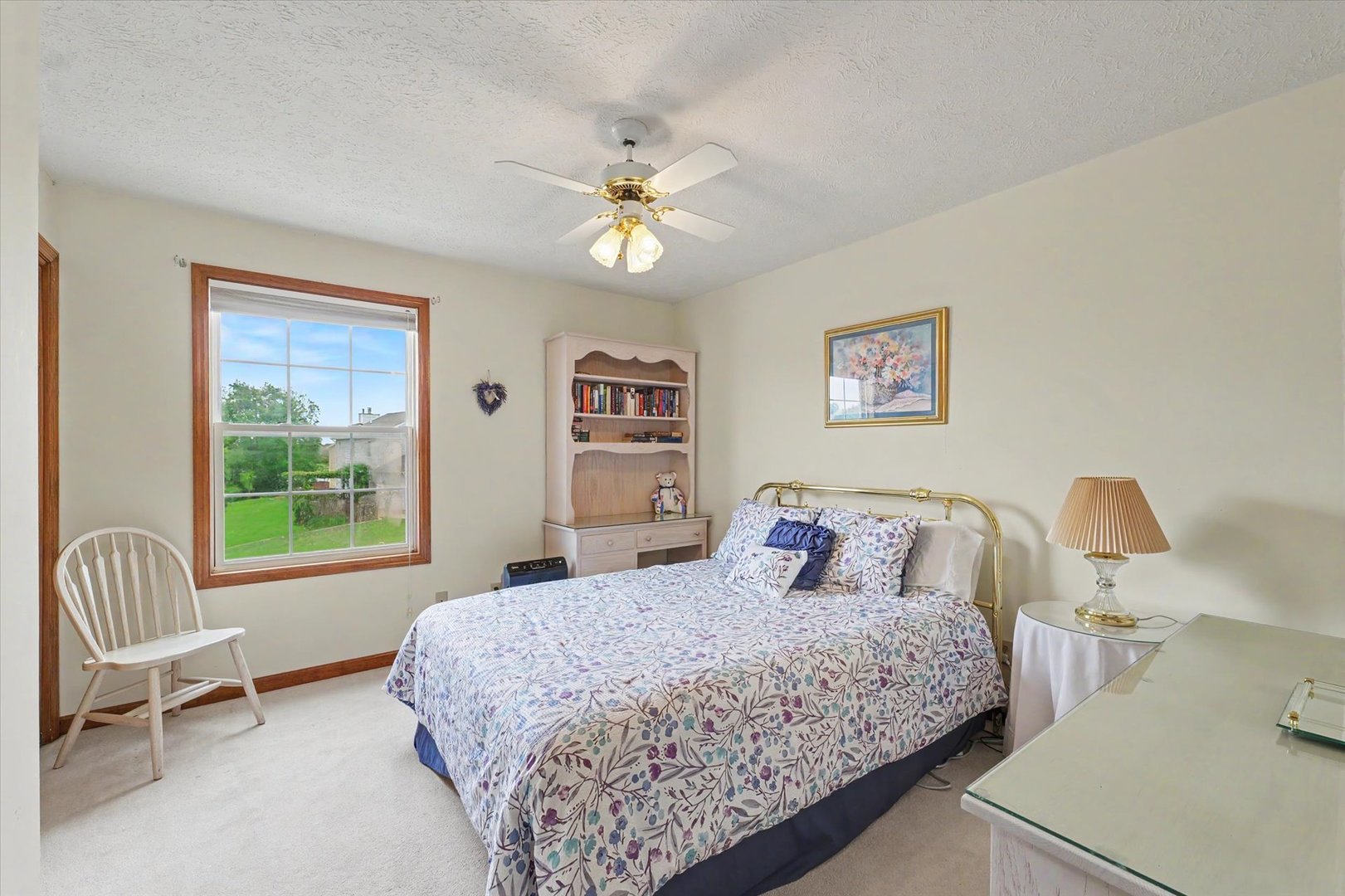 4409 Copper Ridge Road Champaign, IL 61822 - Photo 25 of 40 a bedroom with a bed and a chandelier