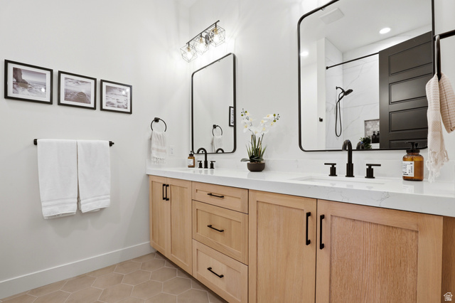 1000 West Upper Cove Road Park City, UT 84098 - Photo 21 of 63 Dual vanity featuring light wood-finish cabinetry, white countertops, and matte black fixtures