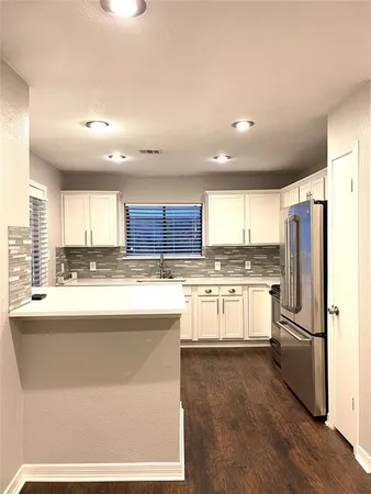 a large kitchen with cabinets