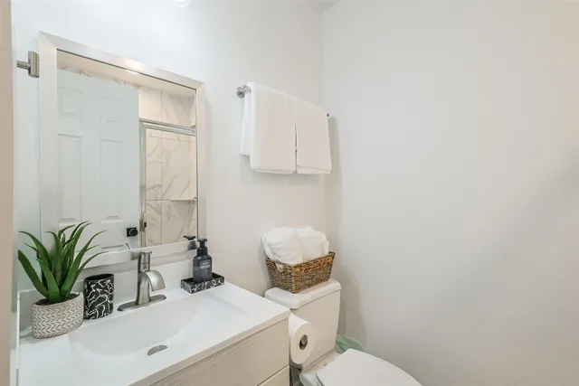 a bathroom with a sink toilet and shower