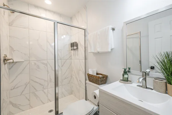 a bedroom with a large bed and a ceiling fan