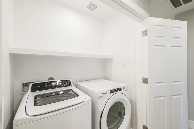 a view of a house with a yard and large tree
