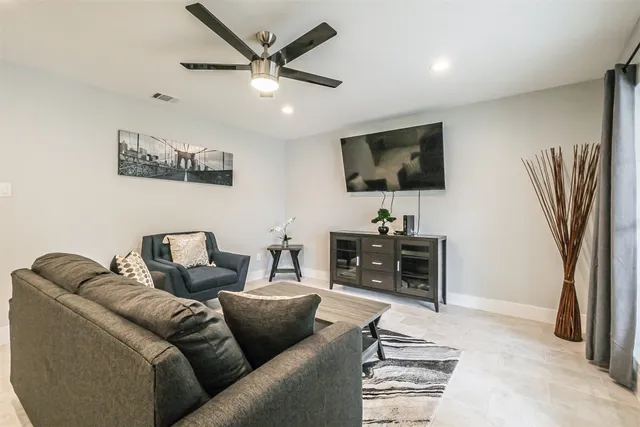 a living room with furniture and a kitchen