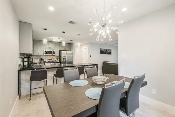 a kitchen with granite countertop a stove and a microwave