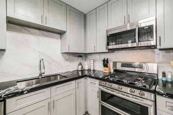 a kitchen with sink and cabinets