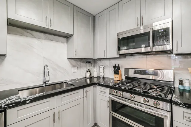 a kitchen with sink and cabinets