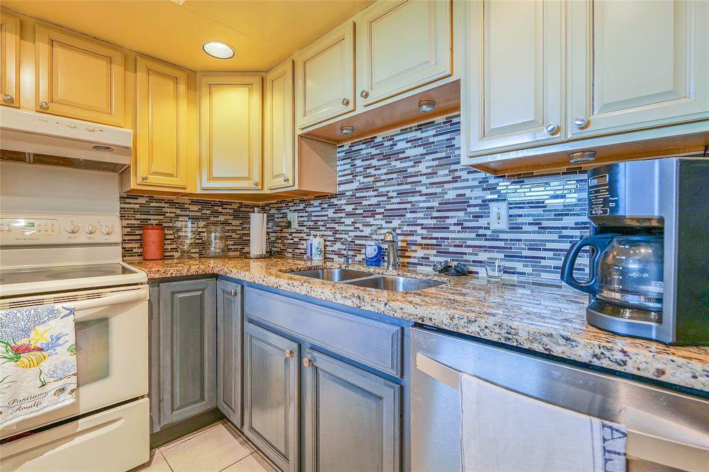 3930 Inverrary Boulevard, Unit 608D Lauderhill, FL 33319 - Photo 17 of 65 a kitchen with stainless steel appliances granite countertop a sink and cabinets