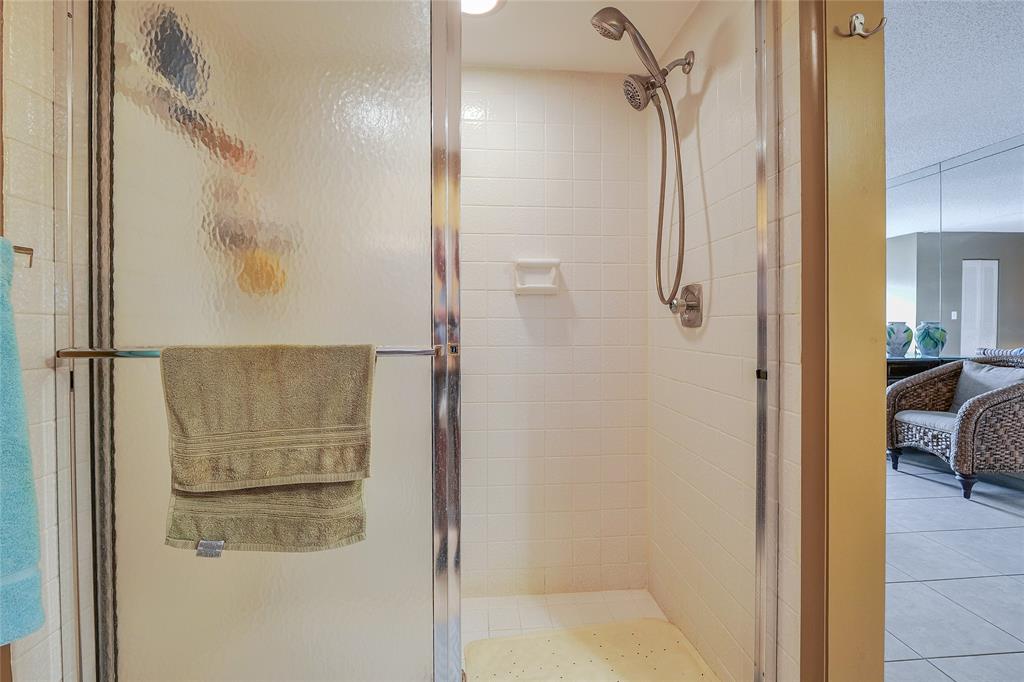 3930 Inverrary Boulevard, Unit 608D Lauderhill, FL 33319 - Photo 25 of 65 a bathroom with a glass shower door