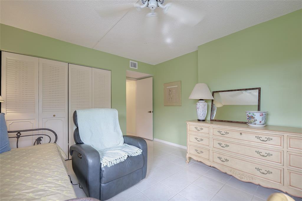 3930 Inverrary Boulevard, Unit 608D Lauderhill, FL 33319 - Photo 27 of 65 a bedroom with a bed and a dresser