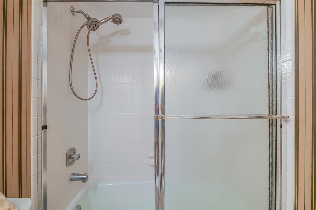 3930 Inverrary Boulevard, Unit 608D Lauderhill, FL 33319 - Photo 30 of 65 a bathroom with a glass shower door