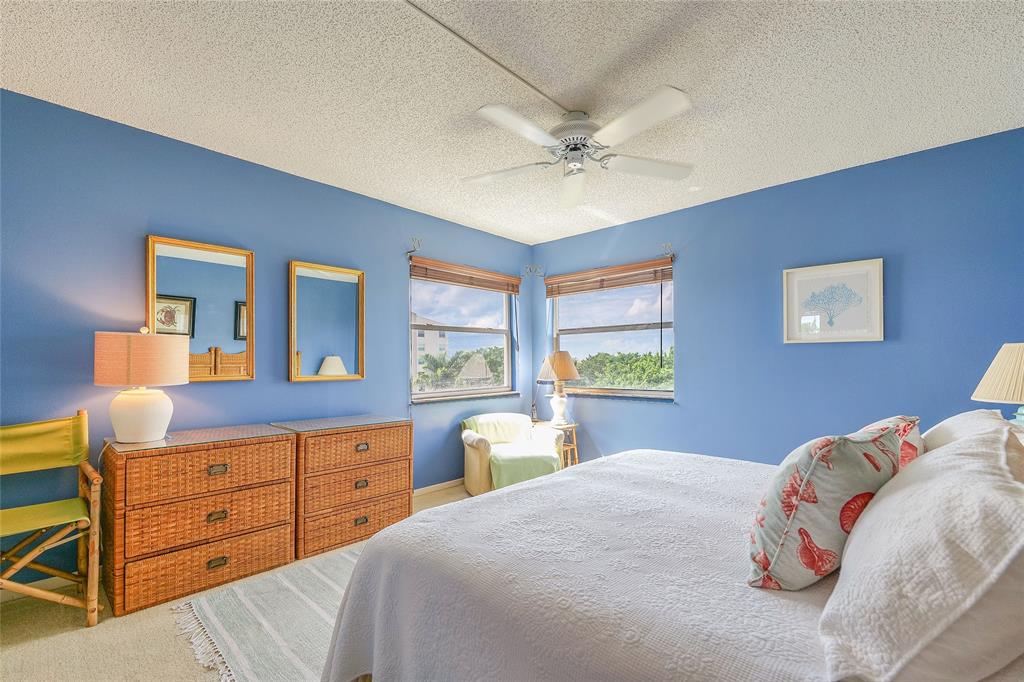 3930 Inverrary Boulevard, Unit 608D Lauderhill, FL 33319 - Photo 31 of 65 a bedroom with a bed and a dresser