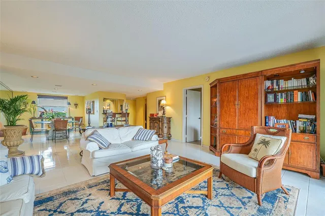 a living room with furniture and a floor to ceiling window