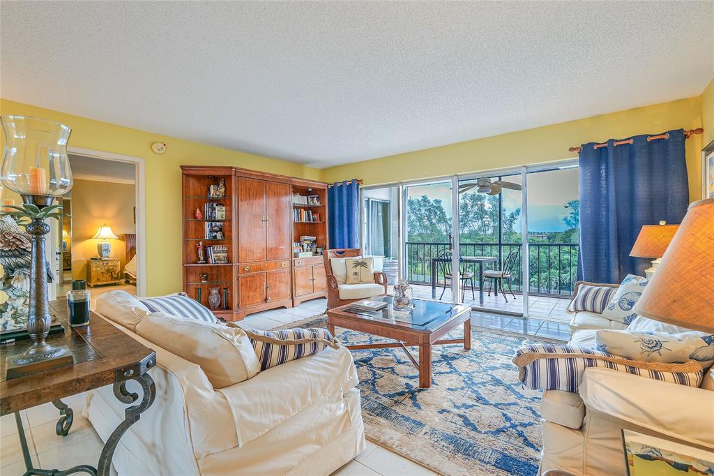 3930 Inverrary Boulevard, Unit 608D Lauderhill, FL 33319 - Photo 6 of 65 a living room with furniture and a large window