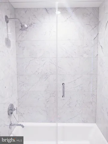 a living room with furniture and a large mirror