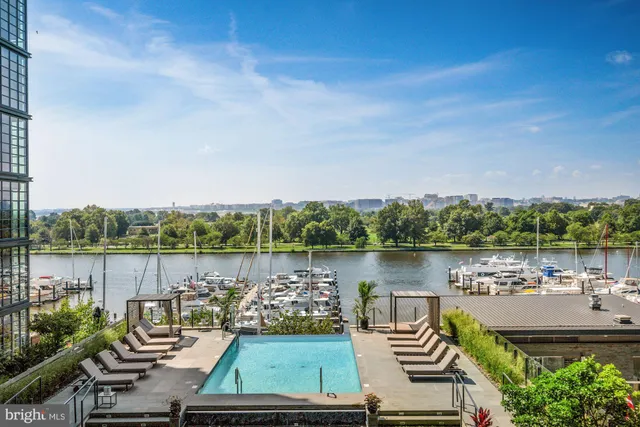 a view of swimming pool with outdoor seating and city view