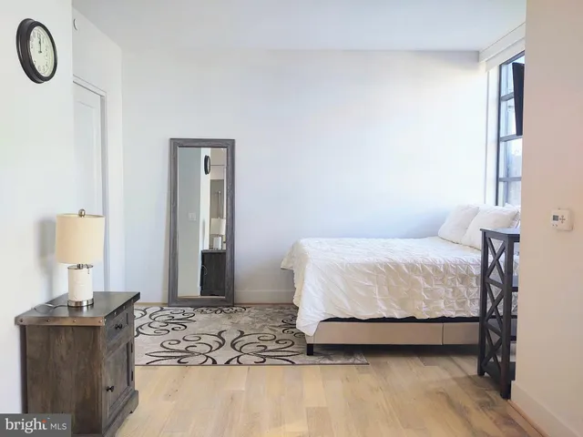 a bedroom with a large bed and a tv