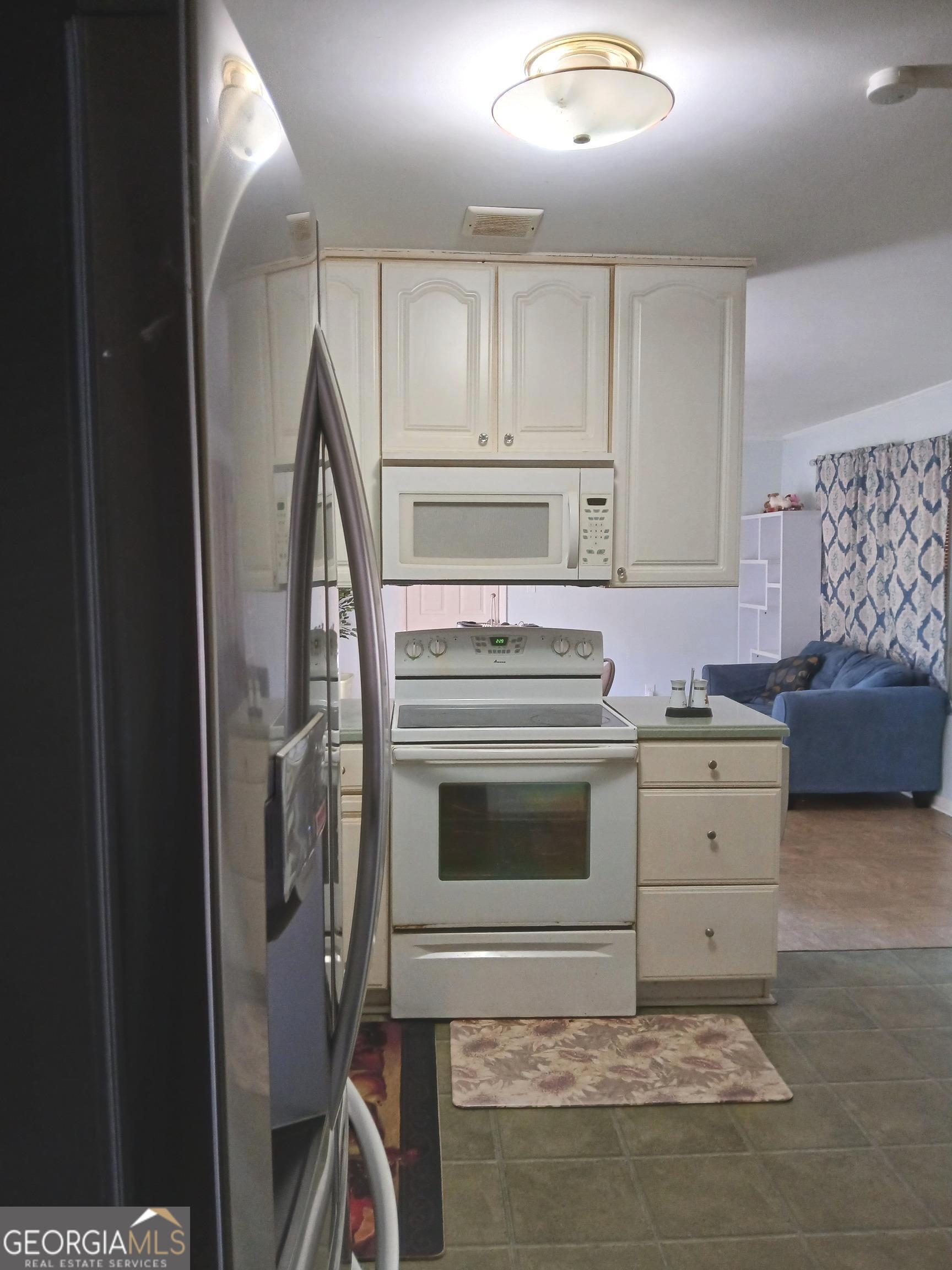 242 Lake Jodeco Road Jonesboro, GA 30236 - Photo 27 of 71 kitchen view to living/dining room combo