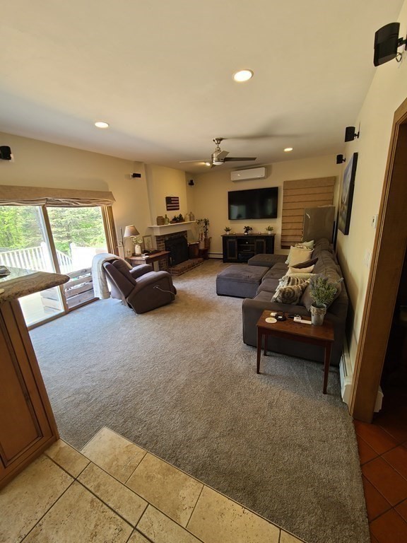 103 Burbank Road Sutton, MA 01590 - Photo 12 of 36 a living room with furniture and a fireplace