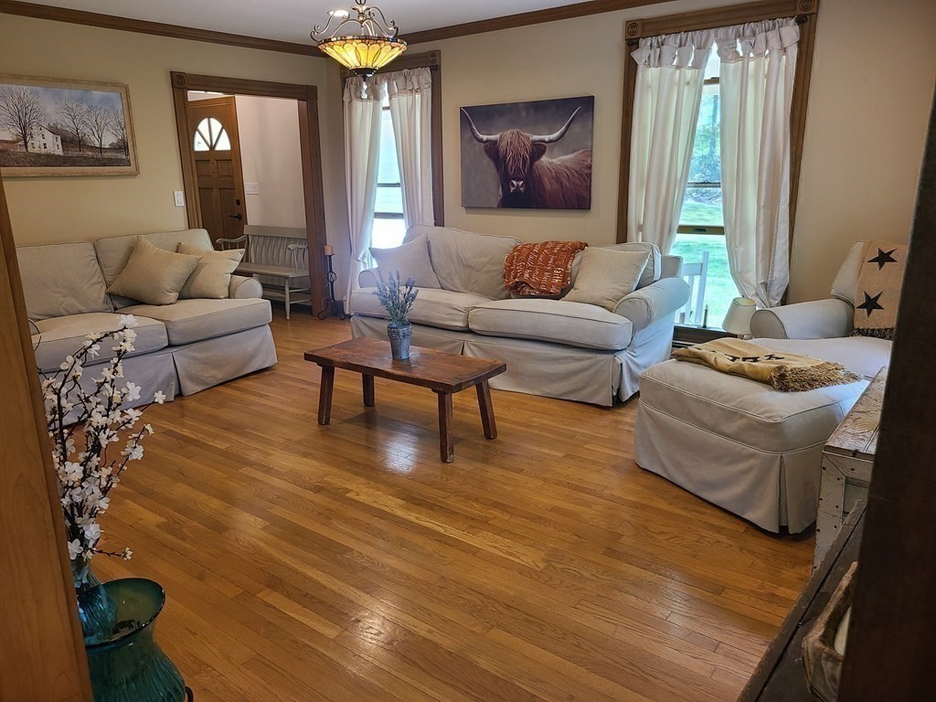 103 Burbank Road Sutton, MA 01590 - Photo 17 of 36 a living room with furniture and wooden floor