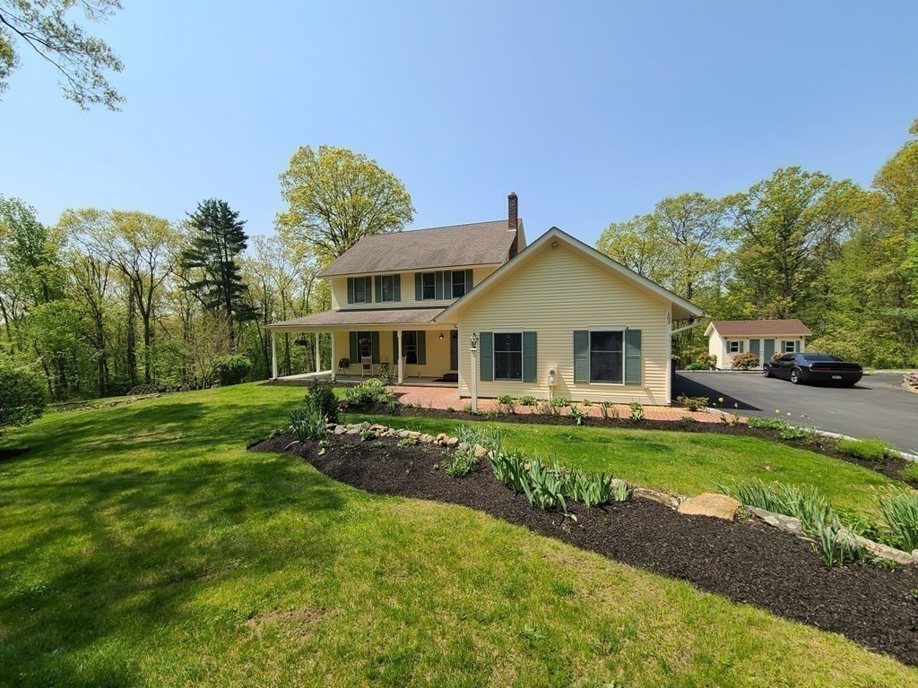 103 Burbank Road Sutton, MA 01590 - Photo 2 of 36 a front view of a house with a garden
