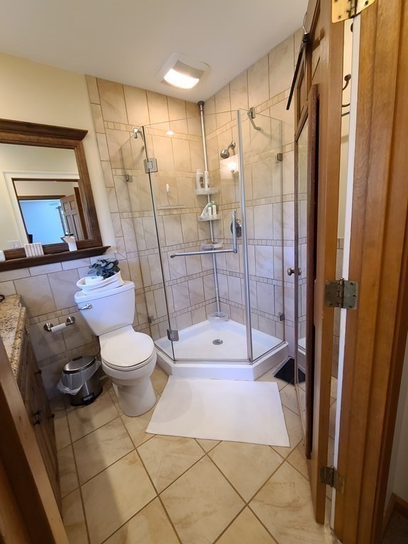 103 Burbank Road Sutton, MA 01590 - Photo 22 of 36 a bathroom with a toilet and shower