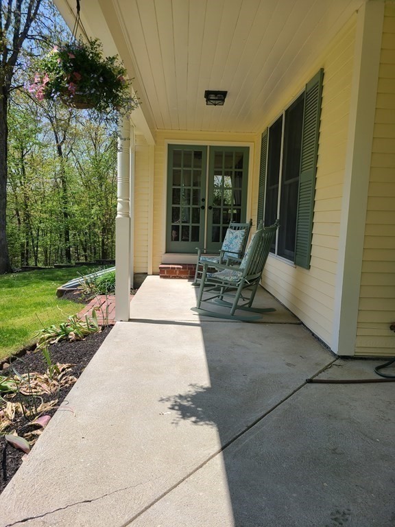 103 Burbank Road Sutton, MA 01590 - Photo 35 of 36 a view of a patio with table and chairs and potted plants