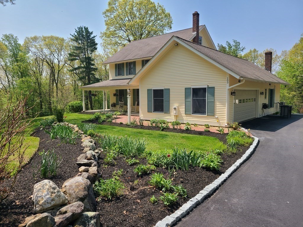103 Burbank Road Sutton, MA 01590 - Photo 5 of 36 a front view of house with a garden and patio
