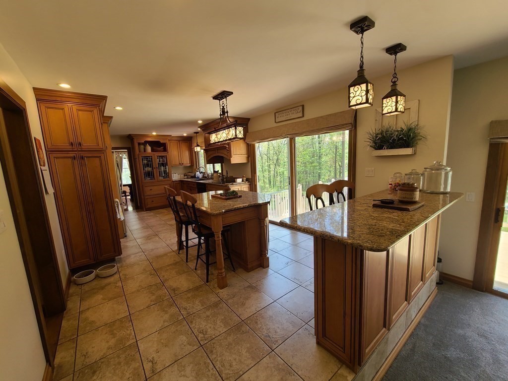 103 Burbank Road Sutton, MA 01590 - Photo 8 of 36 a kitchen with stainless steel appliances granite countertop a refrigerator and a stove