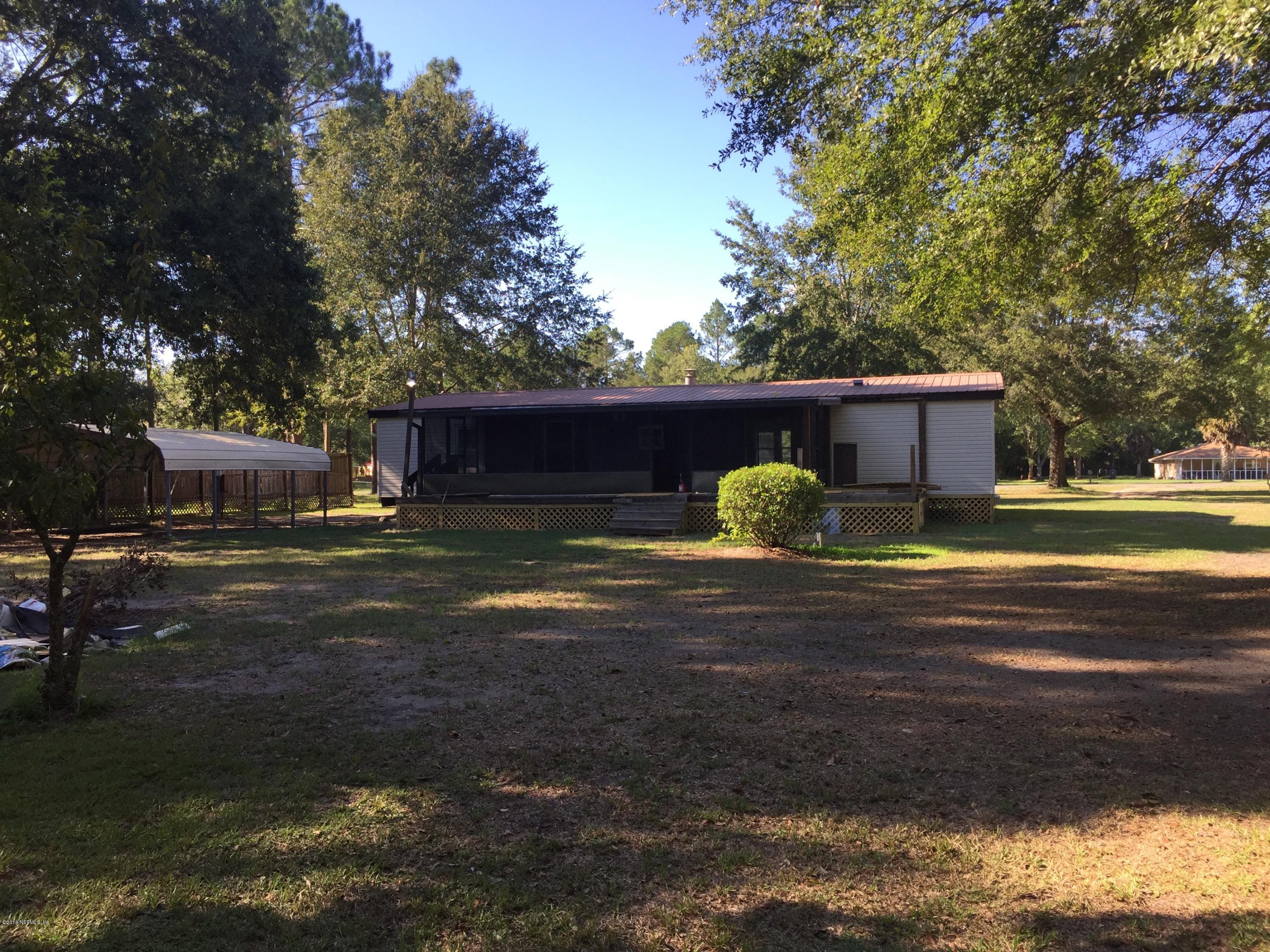 54221 Lawhon Road South Callahan, FL 32011 - Photo 18 of 23 a front view of a house with garden