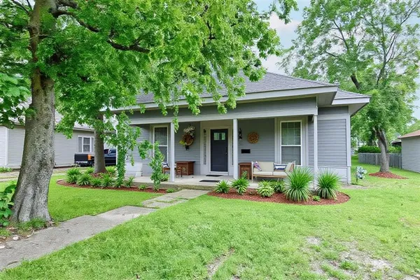a front view of a house with garden and porch