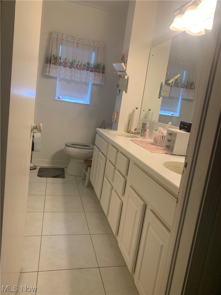 18375 Alexander Road Walton Hills, OH 44146 - Photo 17 of 25 Bathroom featuring dual sinks, tile floors, toilet, and large vanity