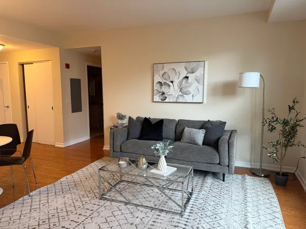 a living room with furniture and wooden floor